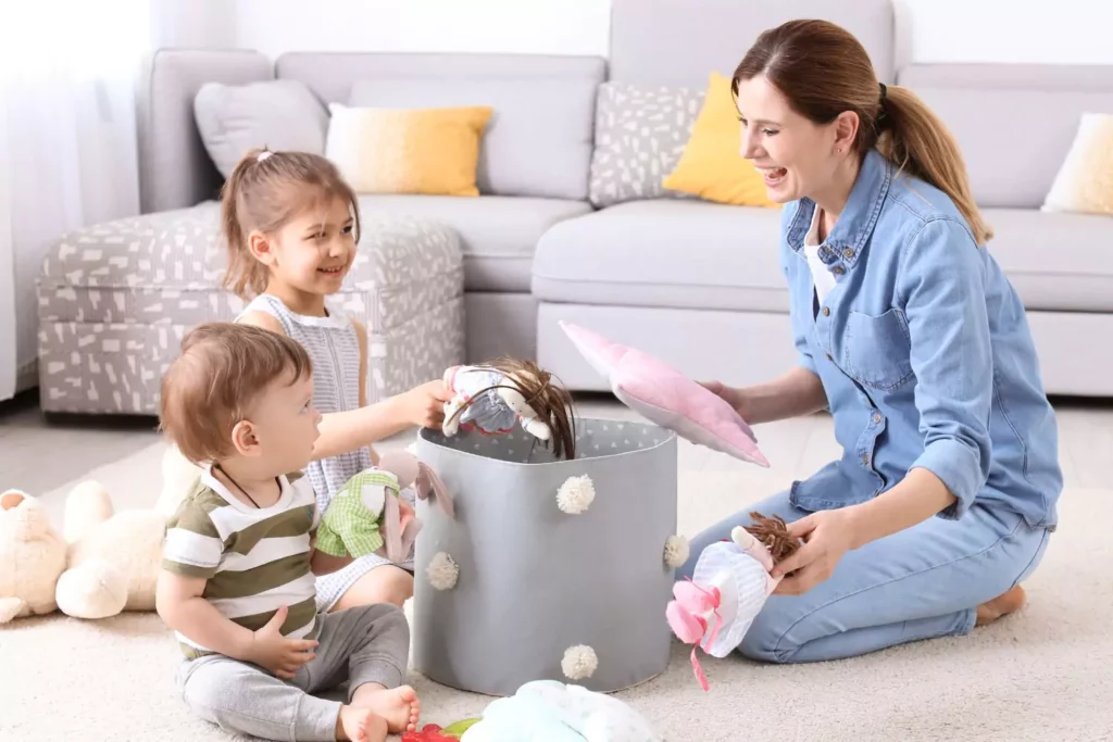 Children picking up their things with their mother