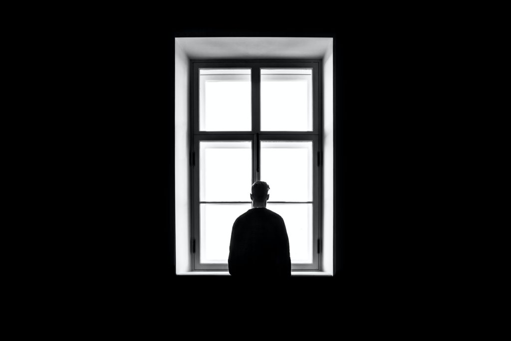 boy looks out window