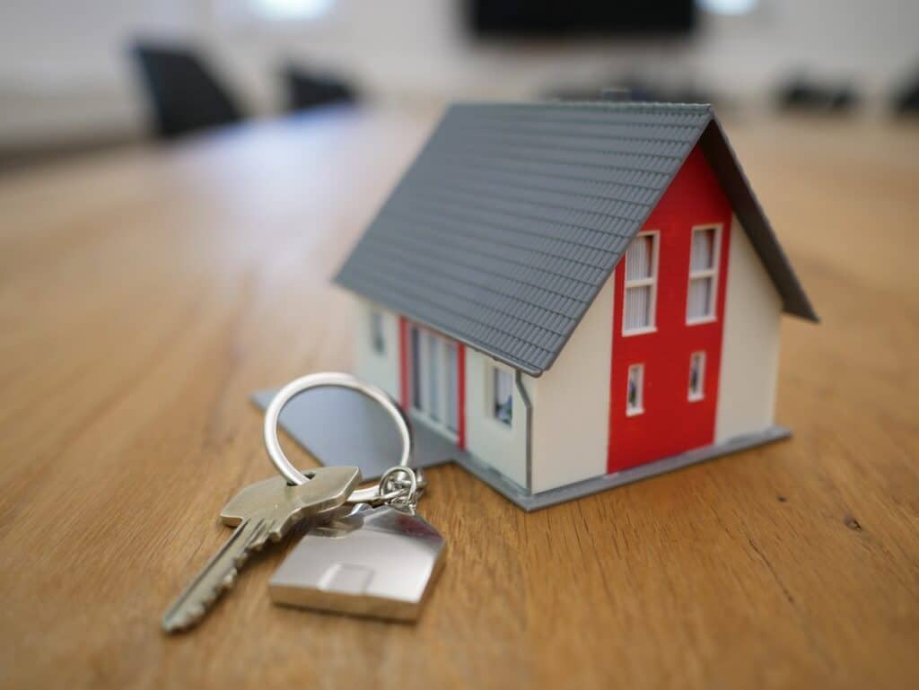 keychain next to small house model