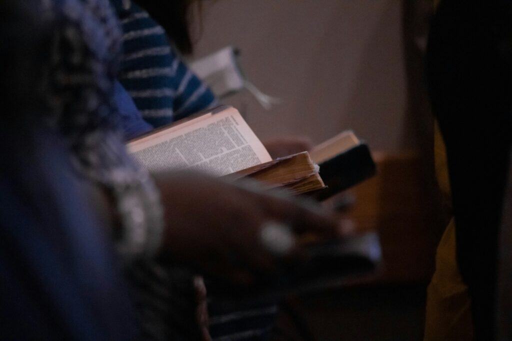 People in worship service holding Bibles
