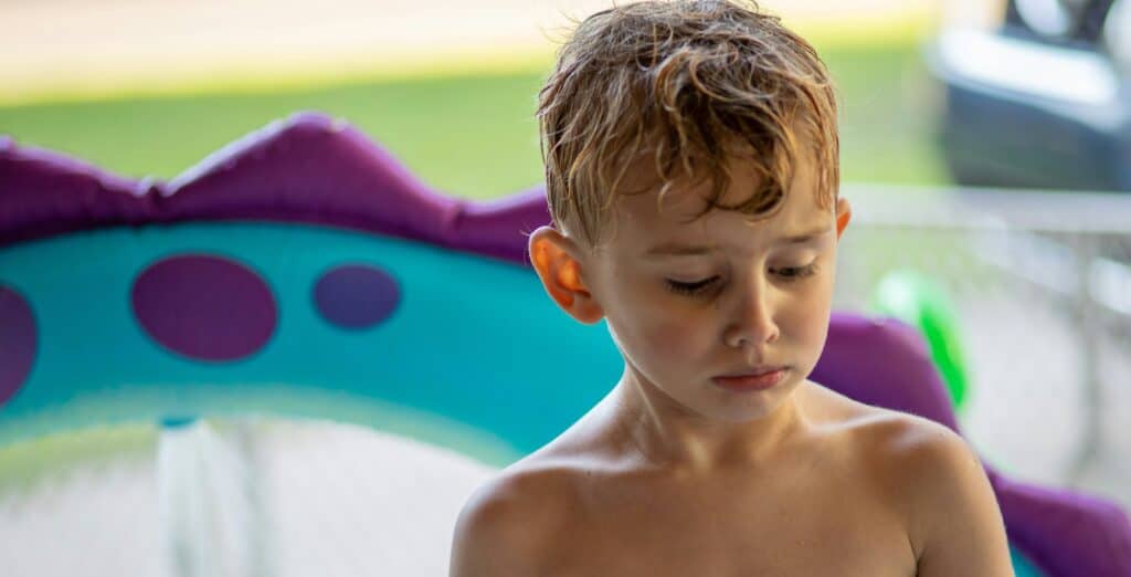 boy frowning swimming pool wet hair