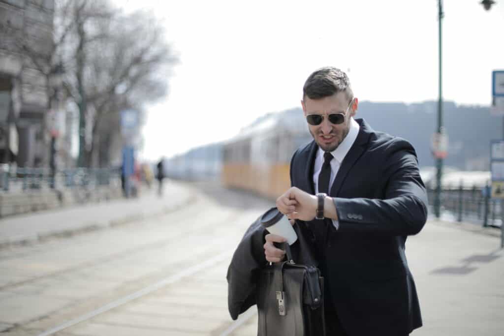 man in suit upset looking at watch