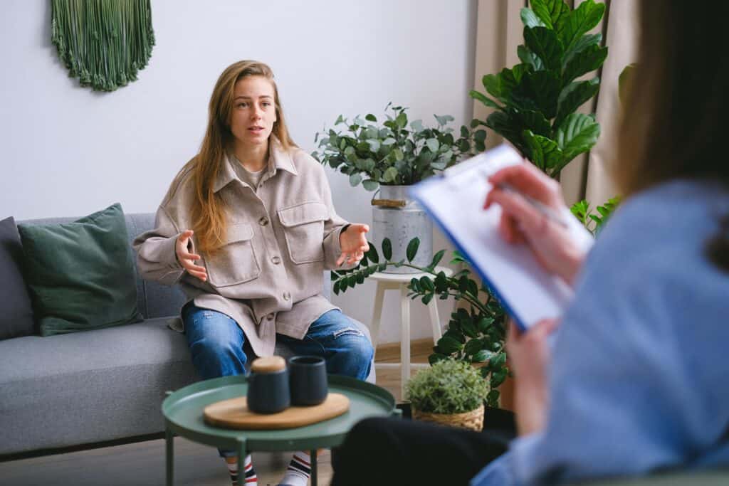 woman on sofa talking to therapist