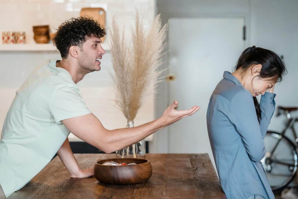 man yelling at woman whose back is to him