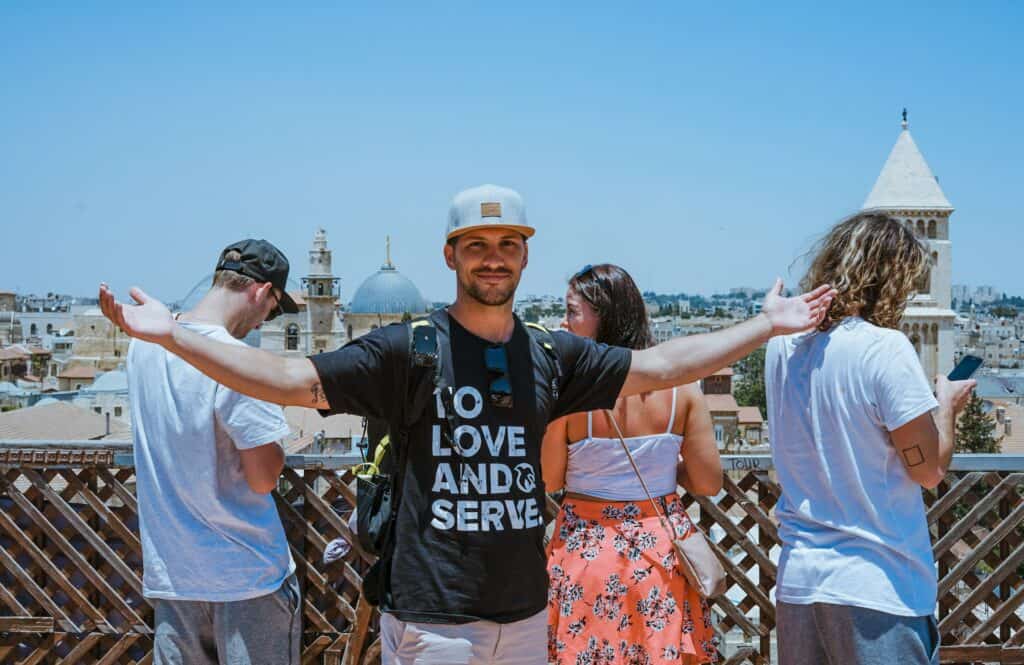 group one man wearing to love and to serve shirt