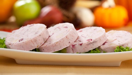 Close up of four slices of a pink-colored, cranberry-flavored dessert