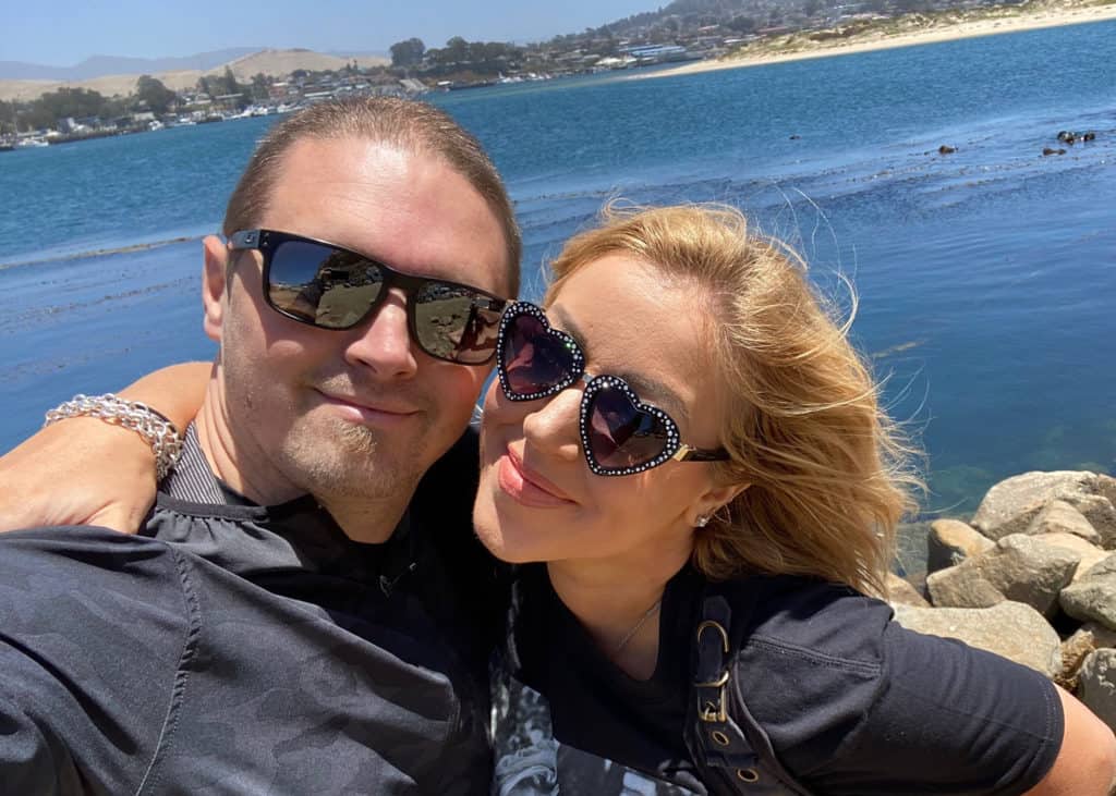 Lynsi-Snyder-Ellingson-and-husband-Sean-smiling-outside-wearing-sunglasses