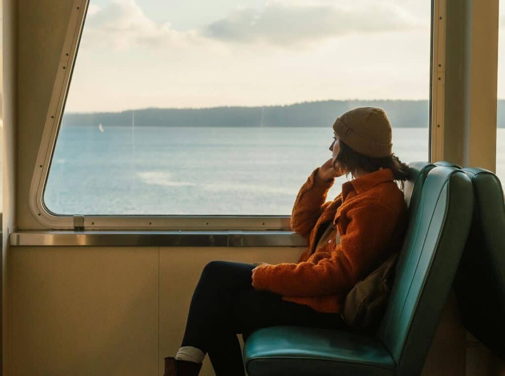 person on boat or train looking out over ocean